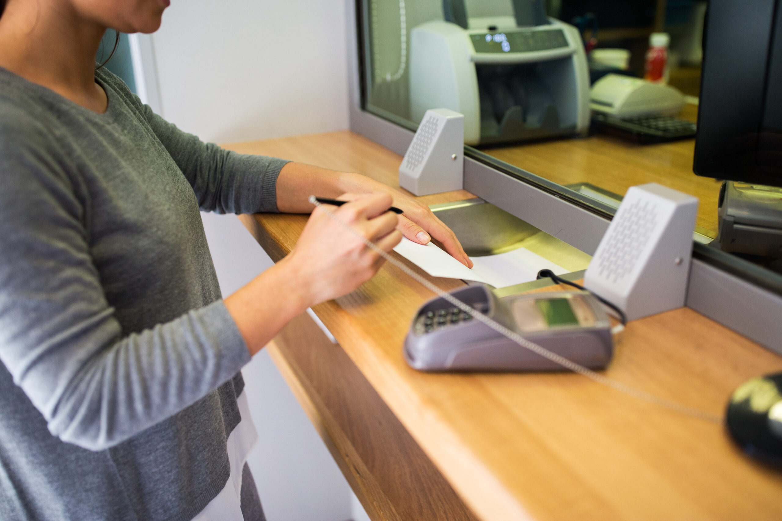 people-finance-concept-customer-with-pen-paper-writing-application-bank-office